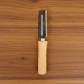 Sharp stainless steel blade of multipurpose vegetable peeler clearly visible