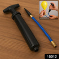 Hand holding the portable ball pump, showing its compact size.