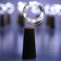 An illuminated wine bottle cork string light creating a warm ambiance on a wooden surface.