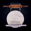Elegant stainless steel stand securely holding a wooden rolling pin on a kitchen counter.