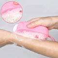 Double-sided silicone bath brush shown in use for a thorough skin cleanse.