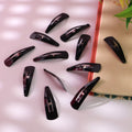 Twelve Matt Black Metal Hair Clips neatly arranged on a clean white background.