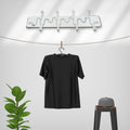 Adjustable wall hook holding various kitchen utensils, showcasing its versatility.