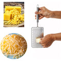 Side view of stainless steel vegetable grater featuring ergonomic handle