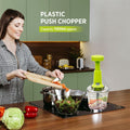 Side view of the manual vegetable chopper, showcasing its comfortable and ergonomic push handle.