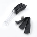The compact blind cleaner brush being used to clean dust from a car's AC vent.
