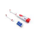 Compact electric toothbrush in hand, highlighting its ergonomic design.
