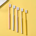 Arrangement of multicolor soft plastic toothbrushes, showcasing the variety in the family pack.