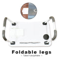 Compact foldable laptop desk shown in a comfortable bed setting.