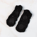 Pair of no-show liner socks laid flat, showing minimal coverage