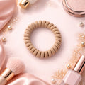 Single soft stretchable spiral coil hair band displayed on a white background.