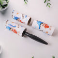 Hand holding lint roller rolling over clothes to remove lint and dust