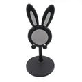 The Bunny Phone Stand in a home office setting, perfect for desk organization.