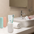 Blue travel toothbrush holder securely containing a toothbrush and toothpaste.