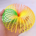 The Rainbow Slinky Toy in its compact, coiled form, displaying its mesmerizing colours.