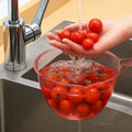Clear plastic utility bowl used in home kitchen for washing