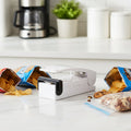 Mini heat sealer sealing a snack plastic bag securely