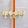 Close-up image of broom holder's multi-roller grip system on wall