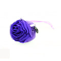 Compact rose-shaped pouch, demonstrating how the reusable shopping bag folds for portability.