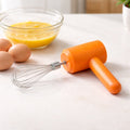 Electric handheld whisk mixer used for beating eggs and mixing batter