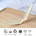 Close-up of comb teeth and brush bristles on foldable tool