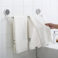 Punch-free towel rod with stable end brackets on smooth bathroom surface