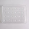 Clear plastic egg container next to traditional egg carton for size comparison