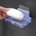 Side profile of the sleek, compact self-adhesive soap holder on a white wall.