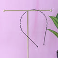 Individual metal wave hair band showing rounded protective tips