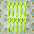 A single reusable plastic spoon placed elegantly on a table setting.