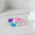 Laundry detergent pod dissolving smoothly in water during washing cycle.