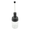 The sleek design of the Heat-Resistant Glass Seasoning Jar on a kitchen counter.