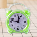 Close-up of quartz alarm clock white dial with bold black numerals
