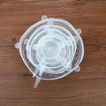 Hand stretching a flexible silicone lid to fit a large bowl.