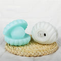 A detailed view of the Pearl Shell Night Lamp's textured surface and illuminated pearl.