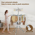 Clothes drying rack in use with multiple hanging garments drying