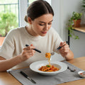 Side view of stainless steel cutlery set with ergonomic plastic handles