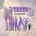 Stainless steel manicure and pedicure tools arranged neatly in the grooming set