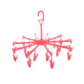 Close-up of the clothes clips hanger securely holding baby clothes for quick drying.