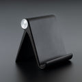 Foldable mobile stand showing adjustable angle on a study table