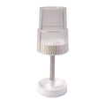 Storage slots of rotating toothbrush holder stand holding toothbrush and toothpaste