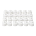 Multiple battery-operated tealights illuminating a dark room.