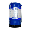 A blue and black LED lantern with a clear body and silver handles stands upright on a white background.