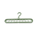 Organized wardrobe interior with multi-hole plastic hangers maximizing storage space.