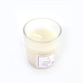 Top view of French Lavender soy candle glowing with warm flame
