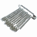 Multiple silver safety pins from the 12-piece decorative brooch set