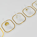 Transparent adhesive hooks installed on a white wall, blending seamlessly with home decor.