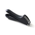 Garlic press kitchen tool placed neatly on a kitchen countertop