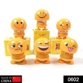 Front view of a funny bobblehead smiling face spring doll for desk decor.