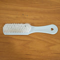 Close-up of ergonomic handle and bristles on handheld cleaning brush